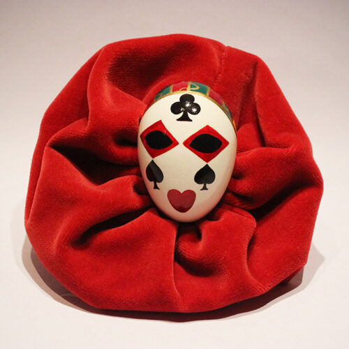 Red harlequin carnival mask hand-painted on eggshell.