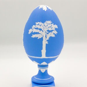 This is a white and blue hand-painted goose egg, depicting a tree