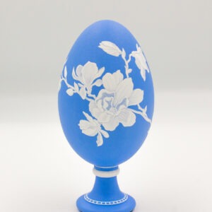 This is a white and blue handpainted goose eggshell, depicting a blossomed flower