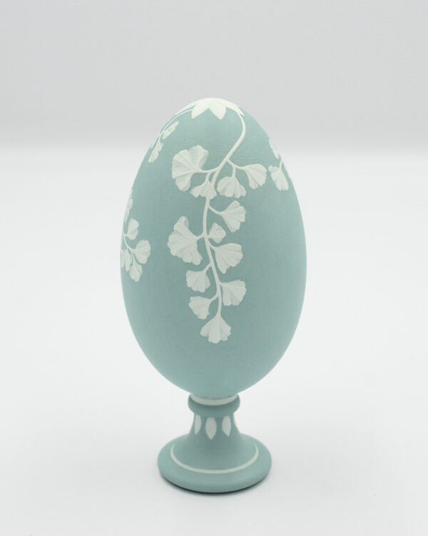 This is a white and green handpainted goose eggshell