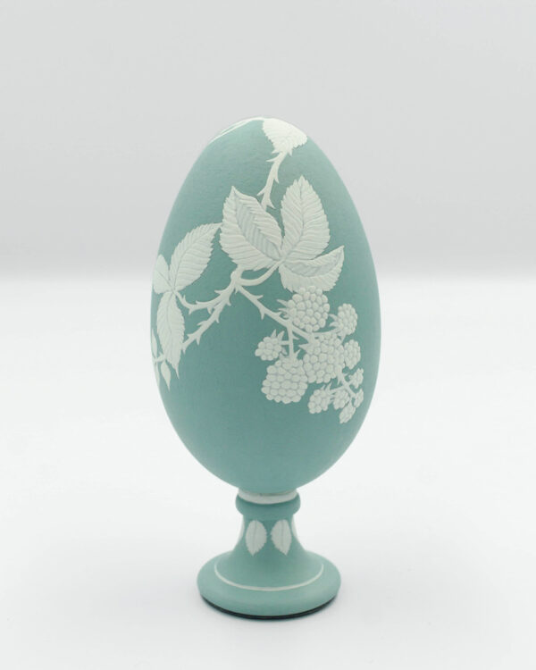 This is a white and green miniature painted goose eggshell